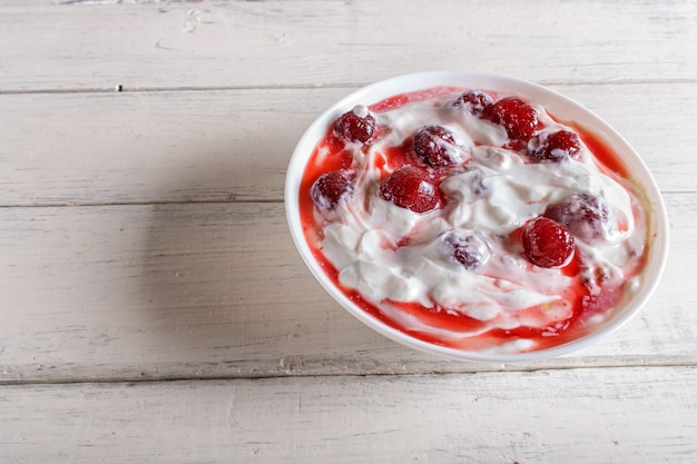 Premium Photo White Plate With Greek Yogurt And Strawberry Jam On White Wooden Background