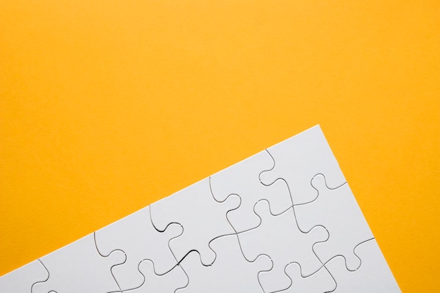White puzzle grid over yellow background Free Photo