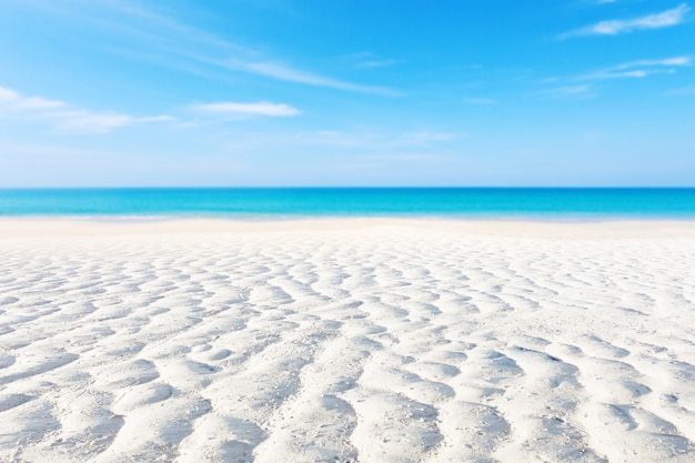 Premium Photo White Sand Curve Or Tropical Sandy Beach With Blurry Blue Ocean And Blue Sky Background