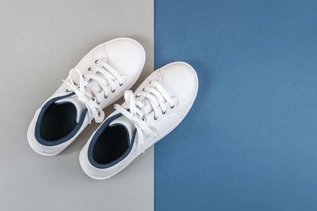 Premium Photo | White sports shoes, sneakers with shoelaces on grey blue