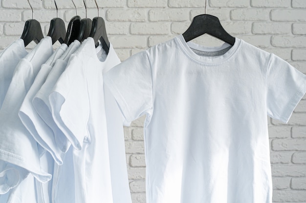 Download White t-shirt hanging on hanger against brick wall, copy ...