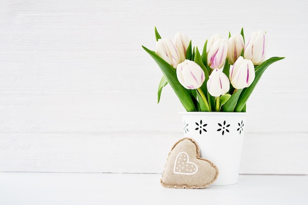 White Tulips Bouquet In White Vase Decorated With Textile Heart