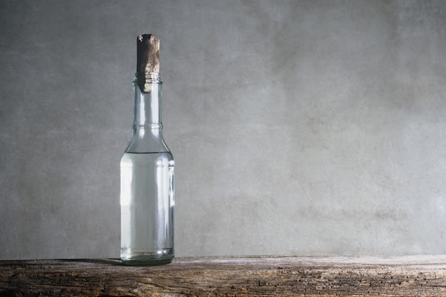 White vinegar bottle on wood table. Premium Photo