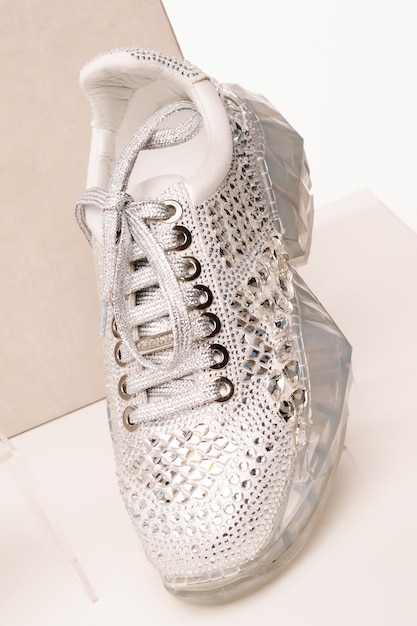 Premium Photo | White women's sneakers are covered with shiny ...