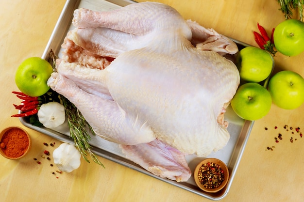 Premium Photo | Whole raw turkey in baking pan ready for cooking. top view.