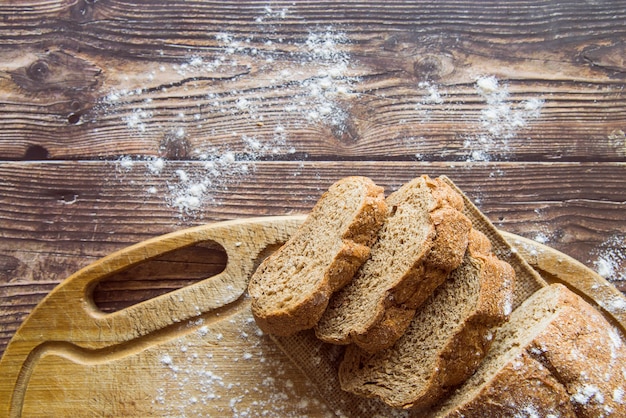 Whole wheat bread on wooden table top view Free Photo