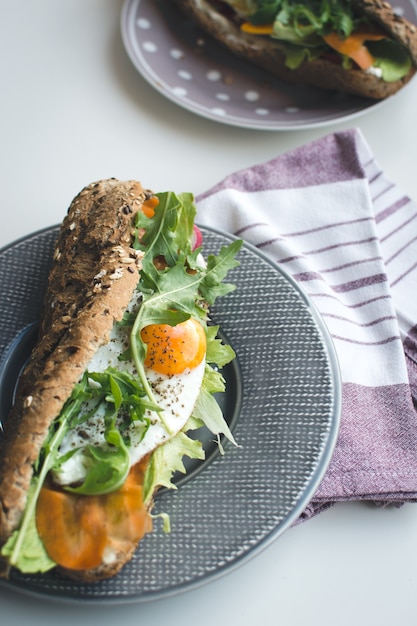 Wholewheat baguette with fried egg and arugula Photo | Free Download