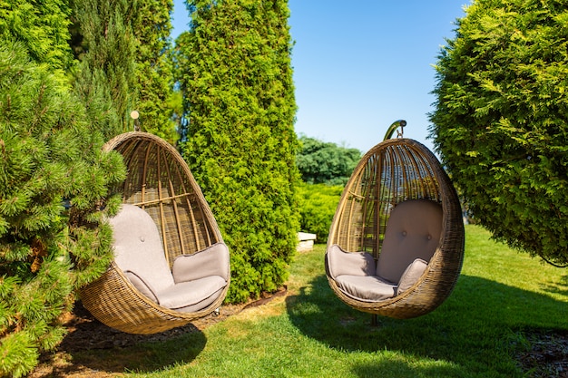 Premium Photo | Wicker chair nest in the garden