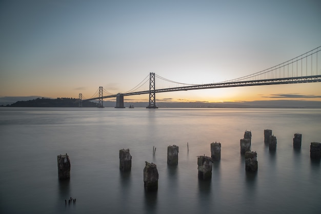 Wide Shot Of Bay Bridge On The Body Of Water During Sunrise In San Francisco California