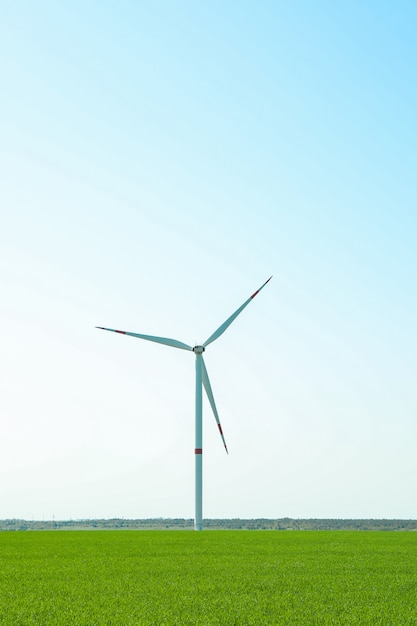 Premium Photo | Wind turbine in a green grass field, space for text ...