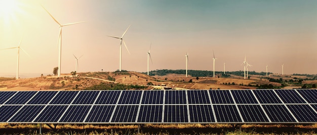 Wind turbine with solar panel on hill and sunshine background. concept clean energy power in nature Premium Photo