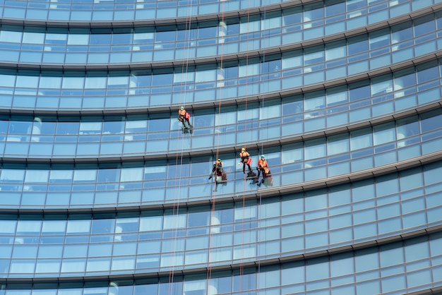 Premium Photo Window Cleaners Suspended On Side Of A Skyscraper