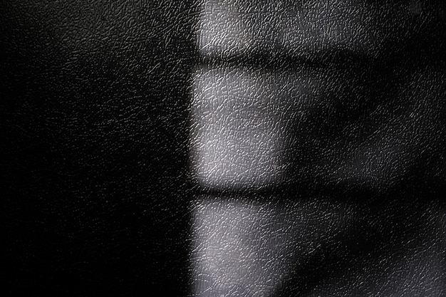 Premium Photo | Window natural shadow on black leather texture ...