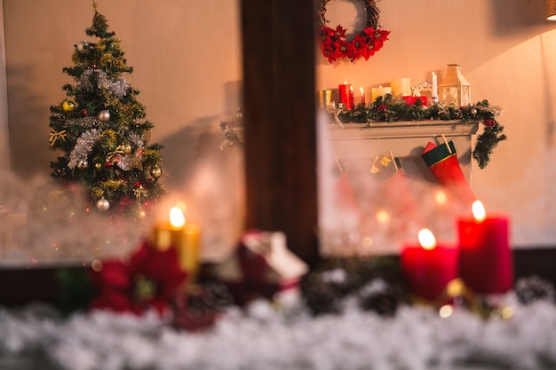 Window with candles and snow and a christmas scene 