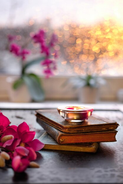 Premium Photo Wintertime With Candle On Stack Of Old Books Pink And