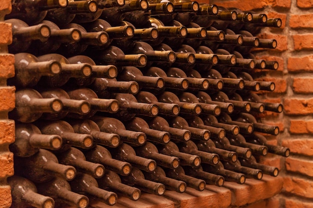 Premium Photo Winy Bottles Lie On Bricks In Basement Old Wine