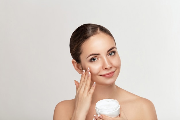 Premium Photo | Woman applying facial cream