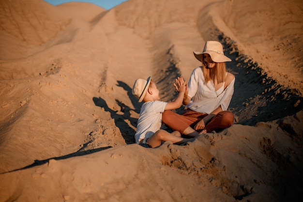 Premium Photo Woman Being Kissed By Her Loving Son During Sunset