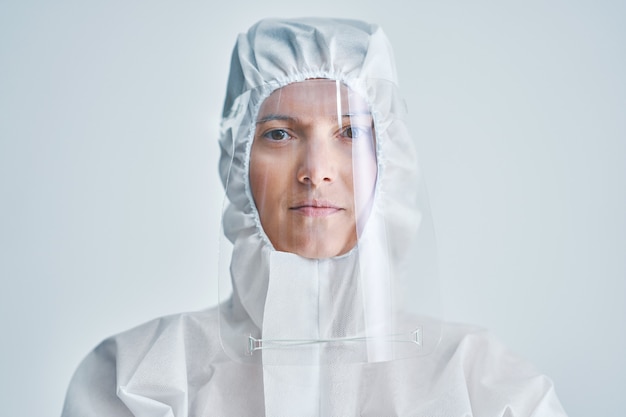 Premium Photo | Woman in bio-hazard suit and face shield on white ...