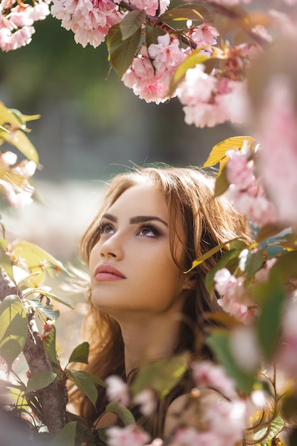 Premium Photo Woman At Blossoming Sakura Tree On Nature