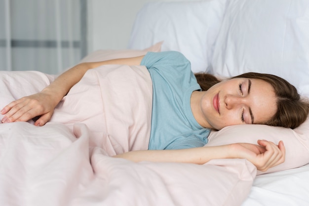 Woman in blue tshirt sleeping Photo | Free Download