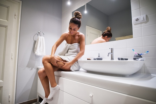 Premium Photo | Woman checking cellulite on the leg in ...