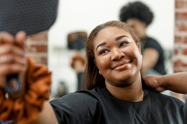 Premium Photo | Woman checking her new hairstyle in a mirror