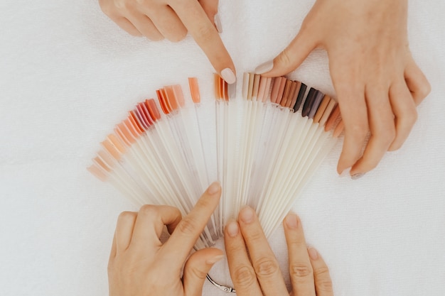 Premium Photo | Woman choosing nail polish color