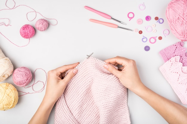 Premium Photo | Woman crocheting with supplies near