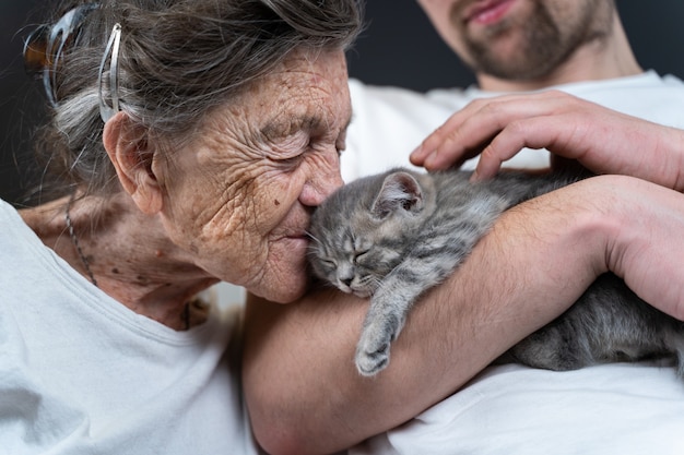 Premium Photo Woman Cuddling And Kiss To Face Small Cute Gray Kitten