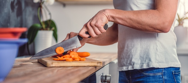 Premium Photo | Woman cutting carrot