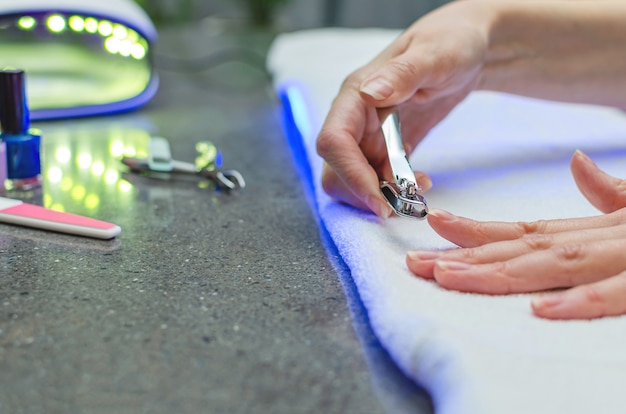 Premium Photo Woman Cutting Nails With Nail Clippers Close Up Home