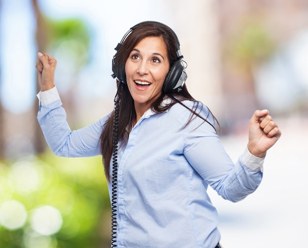 Woman dancing with headphones Photo Free Download