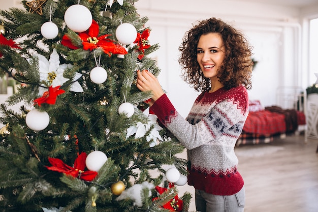 girl decorating christmas tree