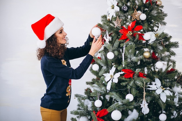 girl decorating christmas tree