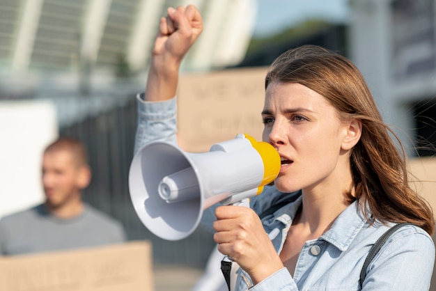 Woman demonstrating with megaphone Photo | Free Download