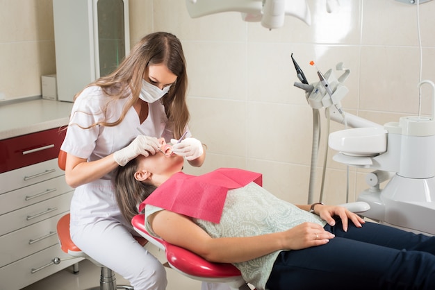 Premium Photo | Woman dentist in her office treating female patient