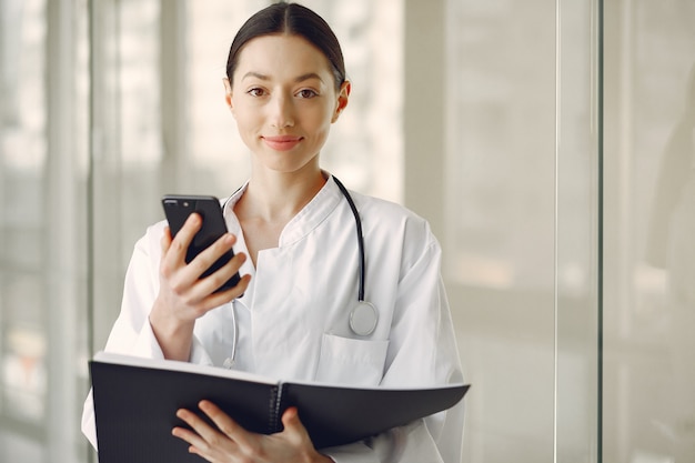 Woman Doctor In A White Uniform Standing In A Hall Free Photo