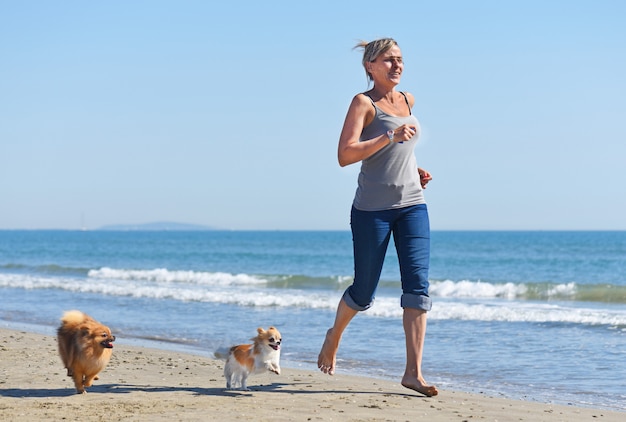 Premium Photo | Woman and dogs on the beach