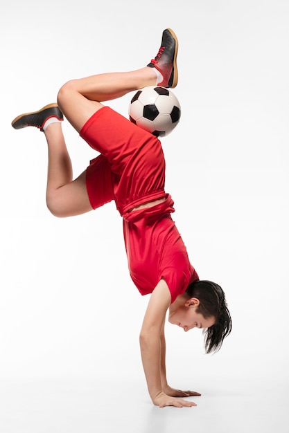 Free Photo Woman Doing Acrobatics With Football Ball