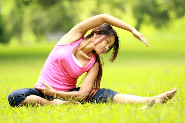 Premium Photo | Woman doing workout on grass