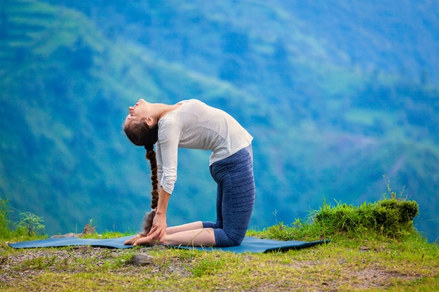 Premium Photo | Woman doing yoga asana ustrasana camel pose outdoors