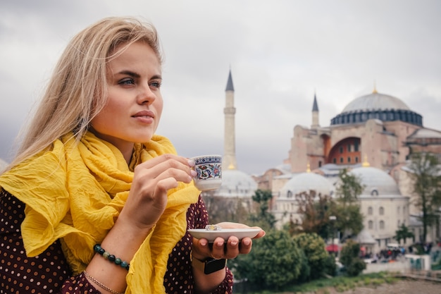 Woman drink turkish coffee near hagia sophia, istanbul ...