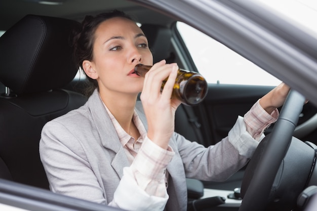 woman-drinking-beer-while-driving_13339-