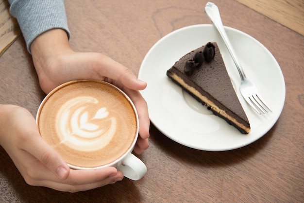Woman drinking cappuccino and eating cake Free Photo Woman drinking cappuccino and eating cake Free Photo