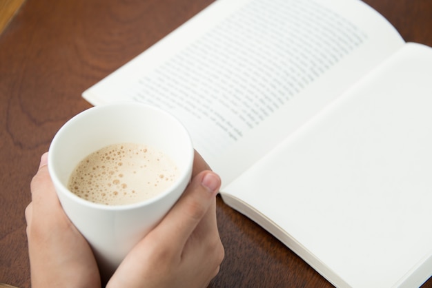 Free Photo | Woman drinking coffee and reading book