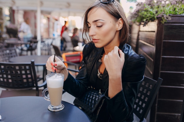 Free Photo | Woman drinking coffee with a straw