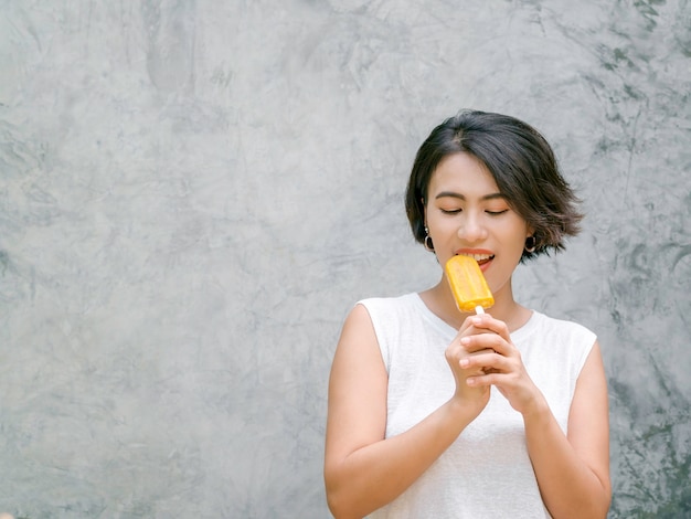 Premium Photo Woman Eating Popsicles Happy Beautiful Asian Woman Short Hair Wearing Casual 