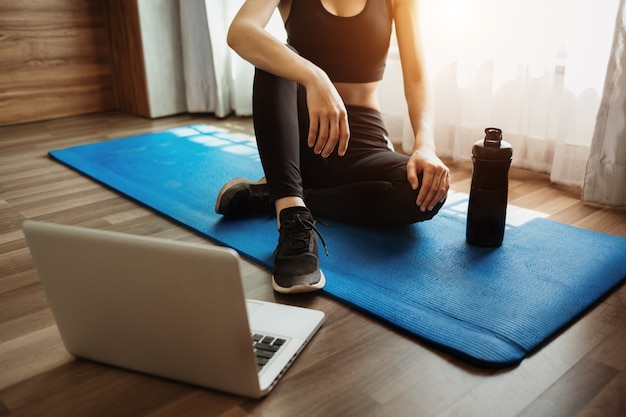 Premium Photo | Woman exercising at home and watching training videos ...