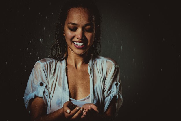 Premium Photo | Woman feeling good and free under the summer rain